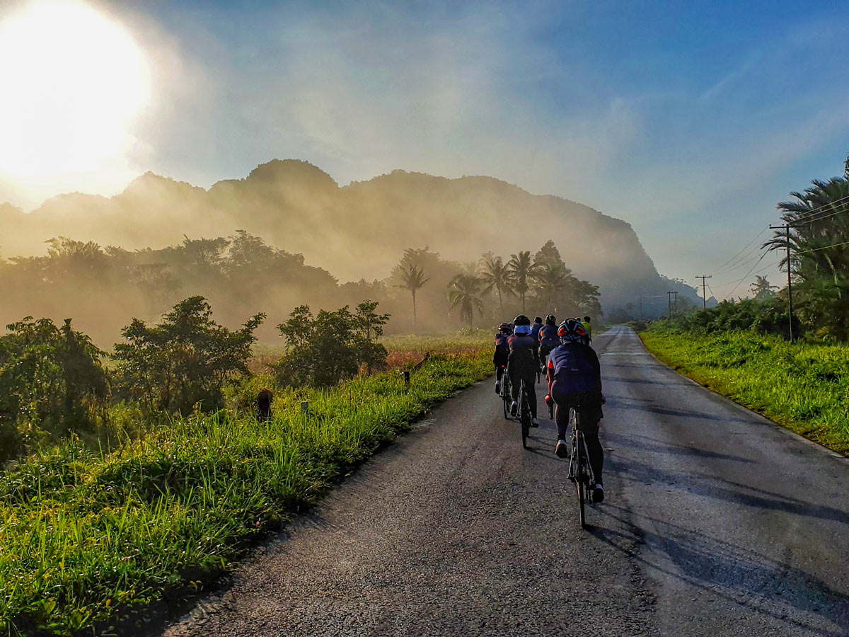 Beautiful road cycling in the sun along Trans Borneo road bike tour Malaysia