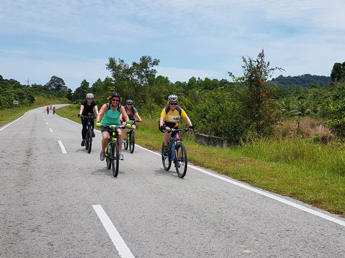 Biking along Sarawak Rainforest Adventure tour in Malaysia