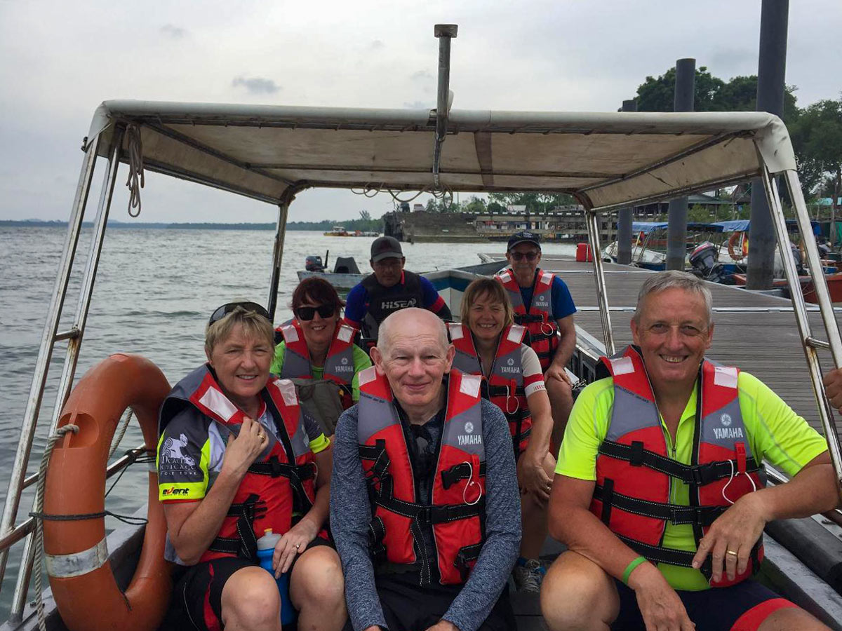 Tour group boat ride along Borneo Wildlife Bike Safari tour Malaysia