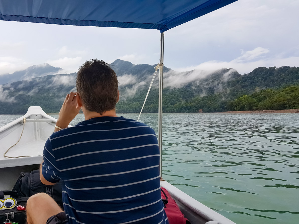 Misty mountains seen from boat ride along Borneo Wildlife Bike Safari tour Malaysia