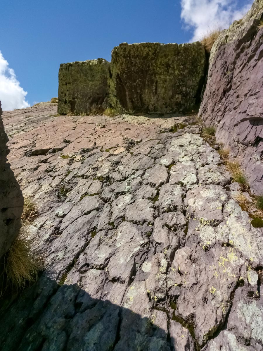 High rock walls and ledges seen hiking along Neolithic tour France