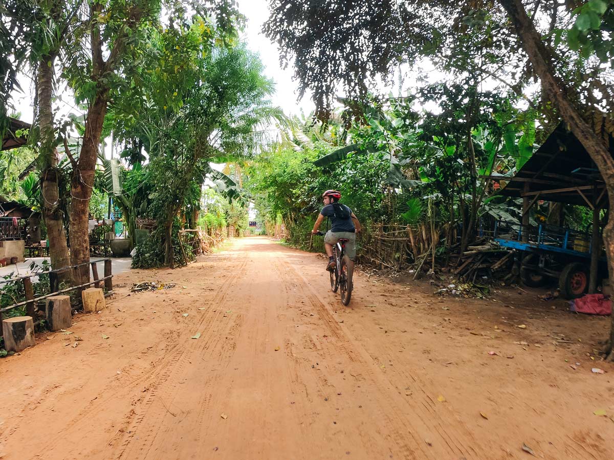 Cycling the dirt road in Cambodia on guided biking tour from Mekong Delta to Angkor Wat