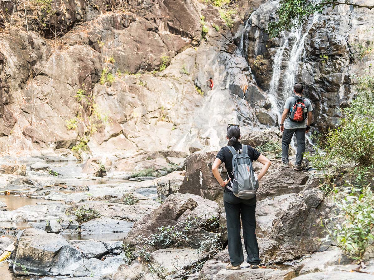 Hikers exploring the waterfalls at the Cambodian countryside