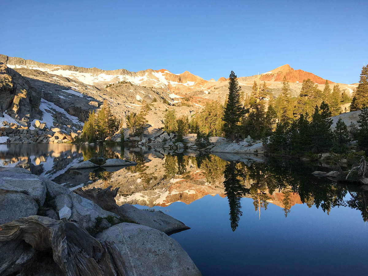 Mountains reflecting in the lake on Red Peak tour