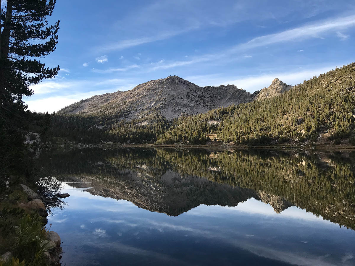 Mountains mirroring in the lake, seen on Rae Lakes Backpack