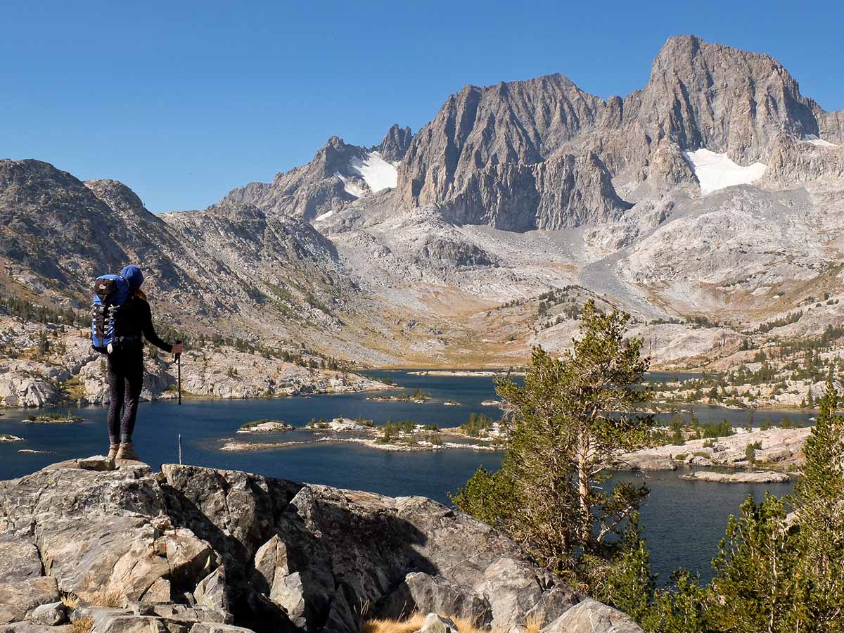 Hiker looking at lake in Ansel Adams Wilderness