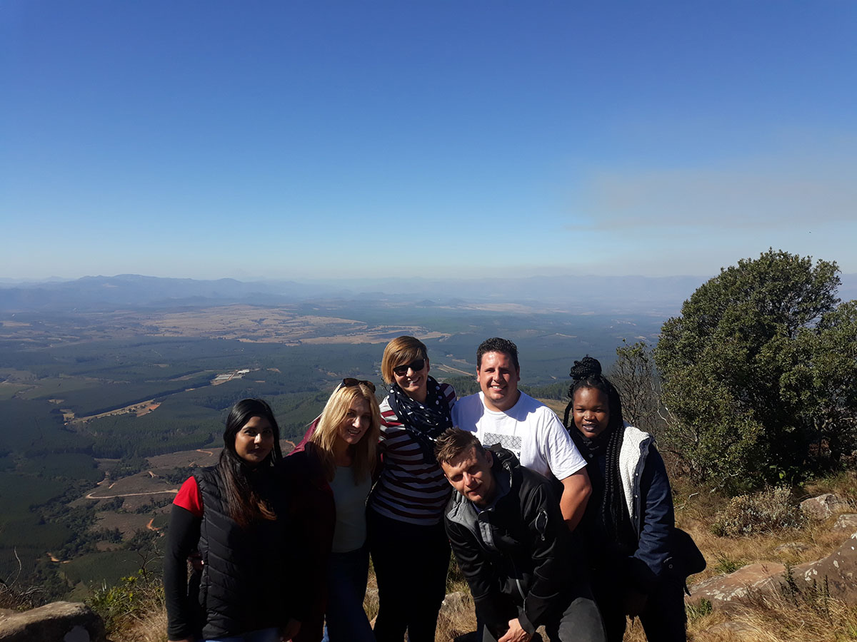 Group of hikers in South Africa posing in front of expansive views