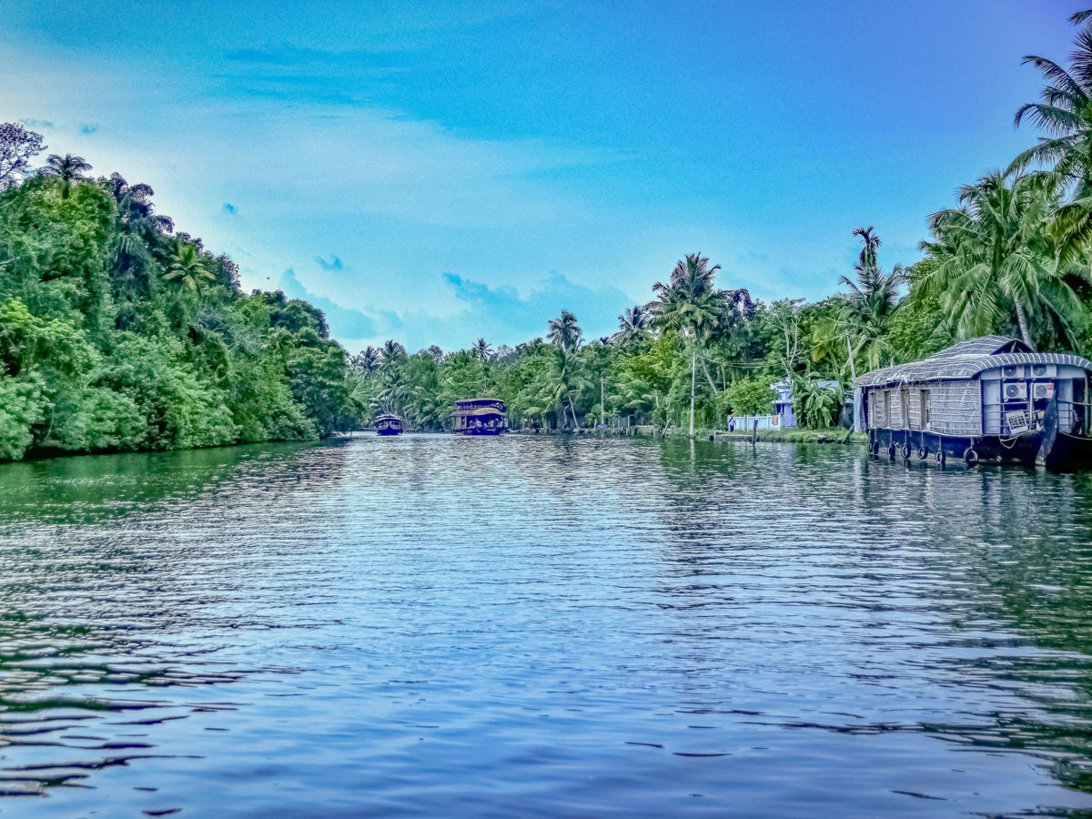 Cycling by rivers jungle house boats on Kerala bike tour India