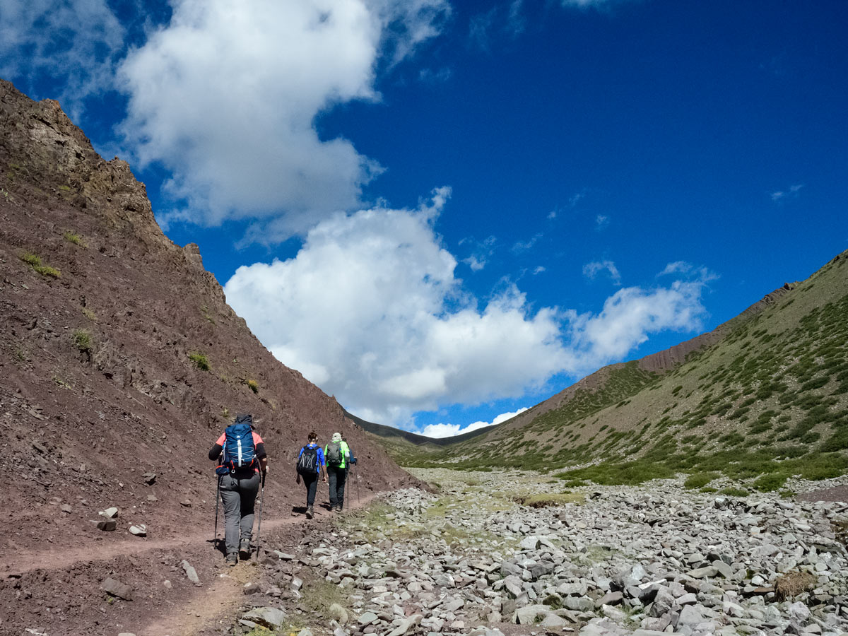 Hikers traverse valley mountains hiking near Ladakh Village India