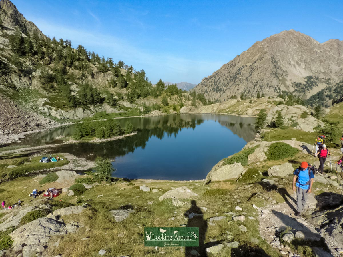 Tourist explore around mountaintop lake along Kings Path trek France