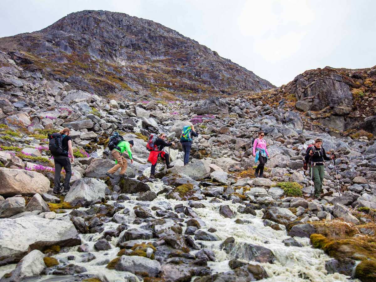 Group of hikers on rocky terrain in Greenland
