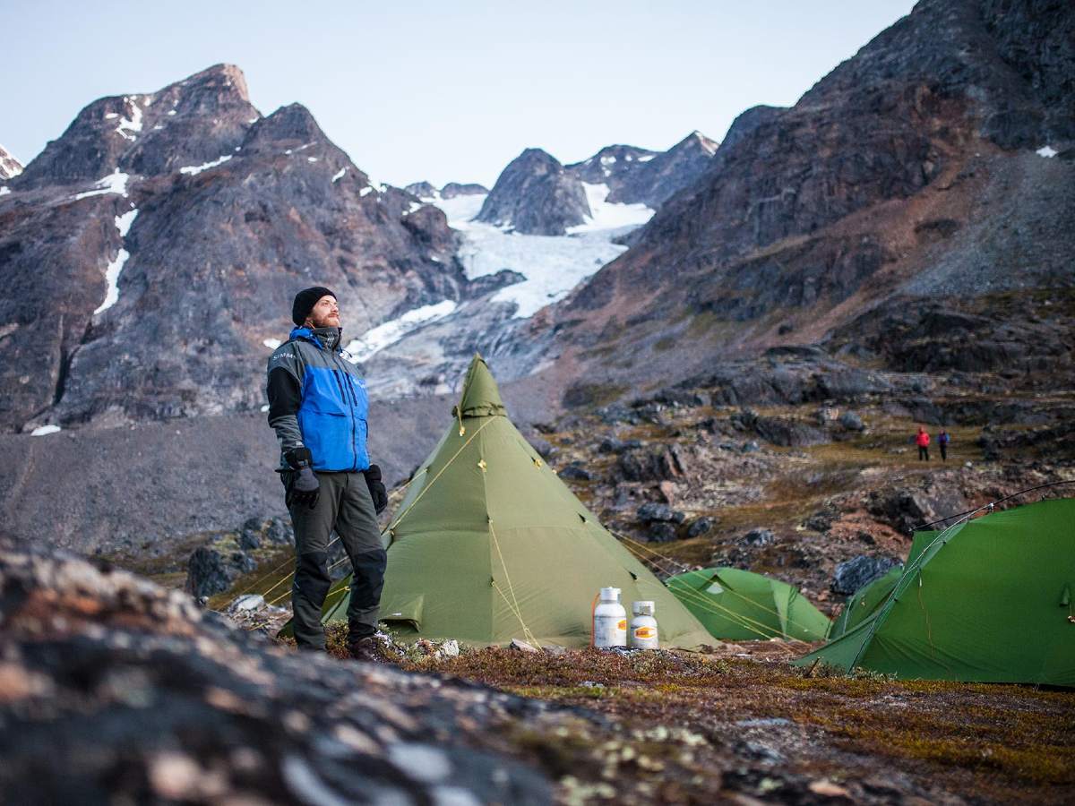 Hiker observing the mountain views in Greenland