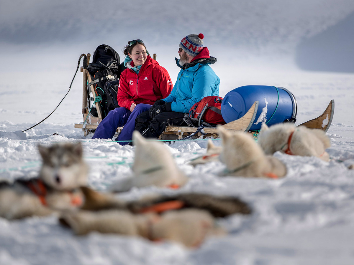 Resting with the sled dogs along Dog Sledding tour in Greenland