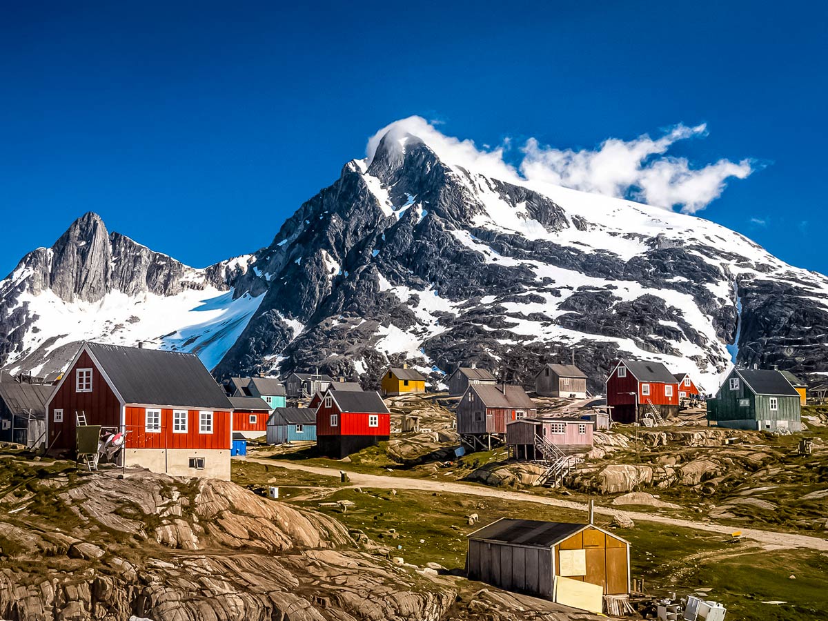 Hiking to remote villages colourful houses Greenland
