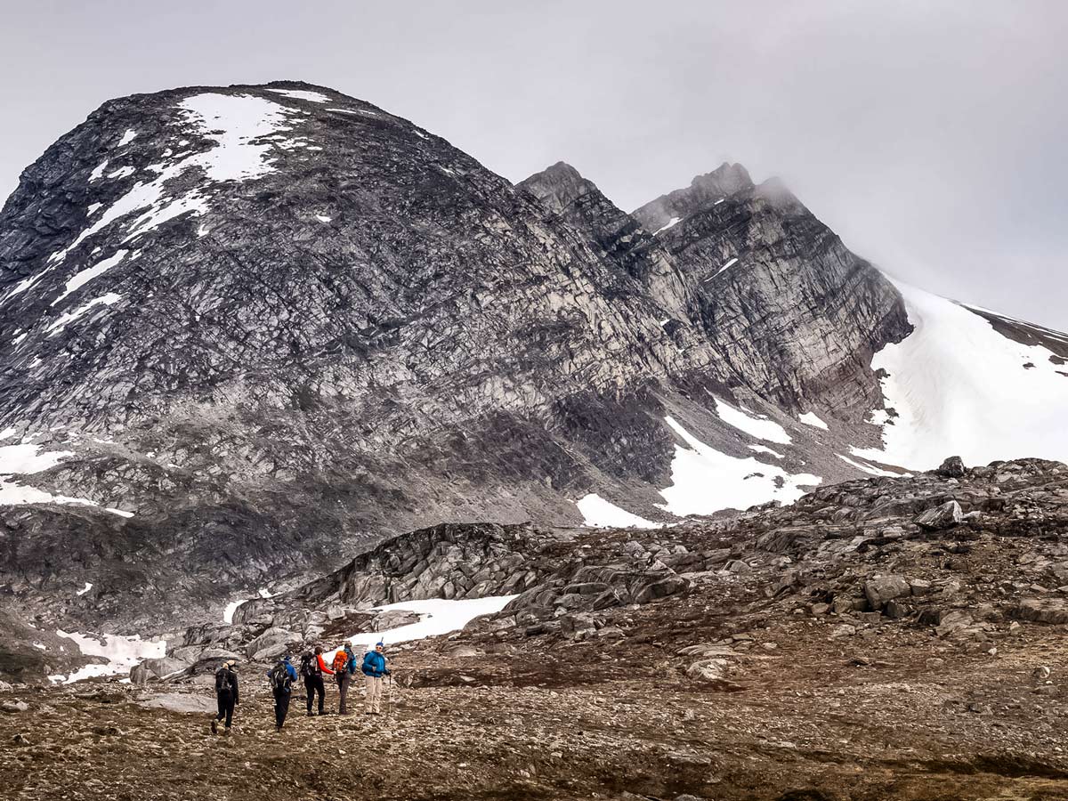 Approaching large rocks moutains hiking trekking tour Greenland