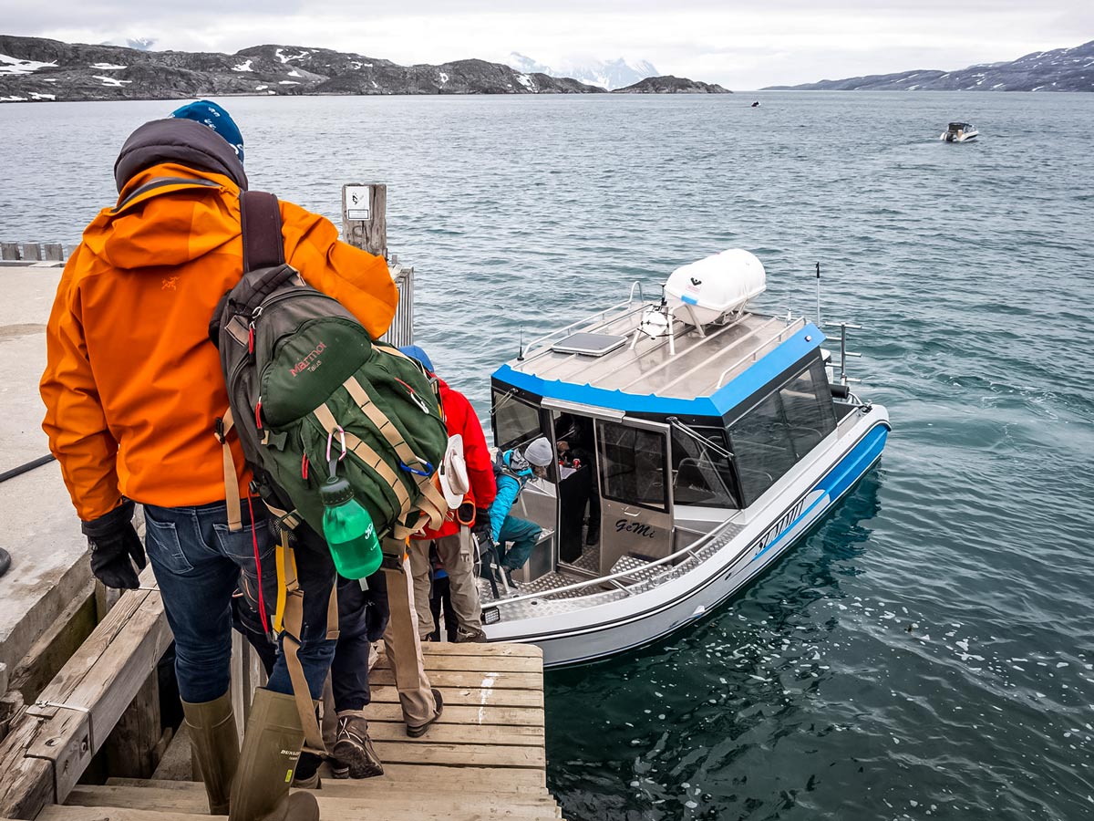 Trekking tour group boarding boat trasportation hiking in Greenland