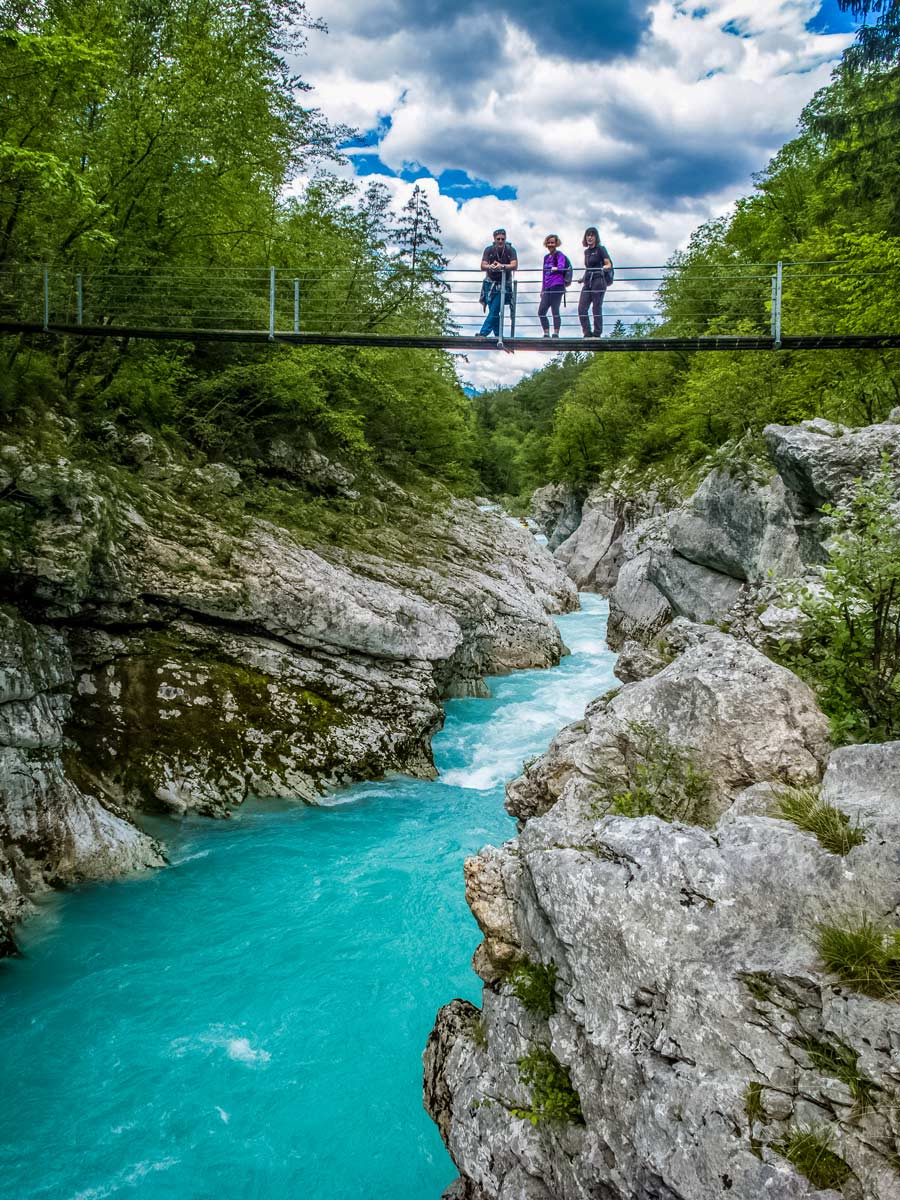 Brige over turquoise river seen biking mountains in Sovenia