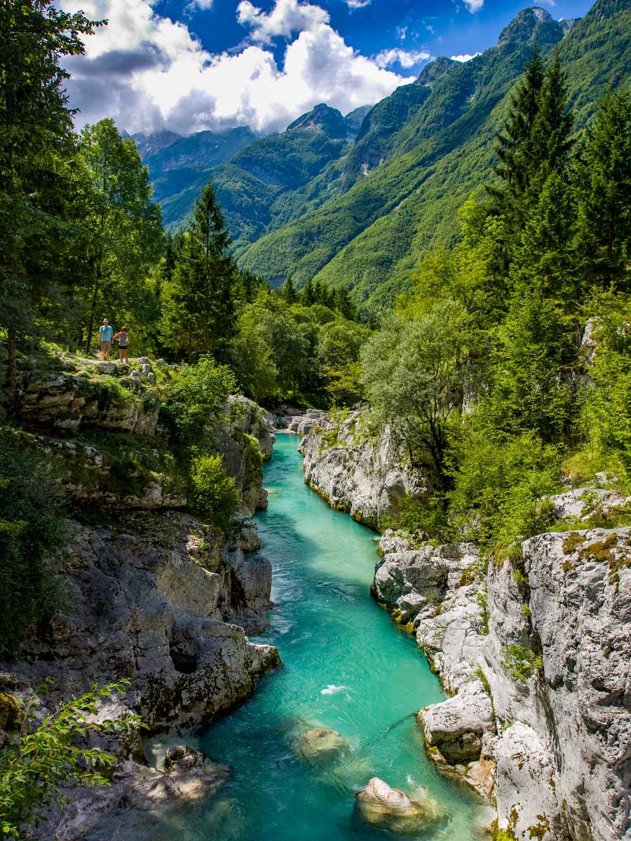 Hikers bikers stand above river gorge beautiful scenary in Slovenia