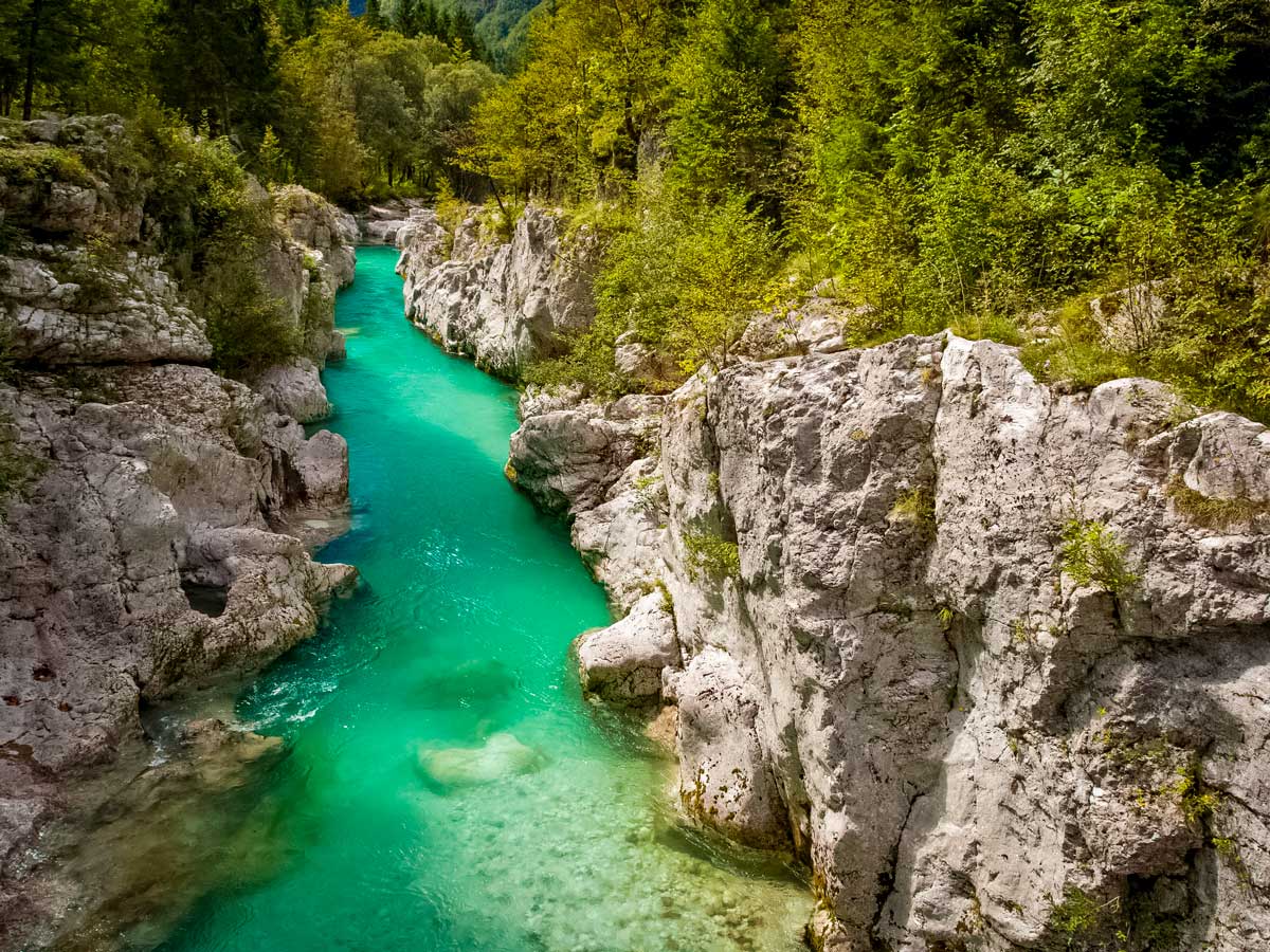 Stunning aqua turquoise blue river in the mountians of Slovenia hiking walking biking tour