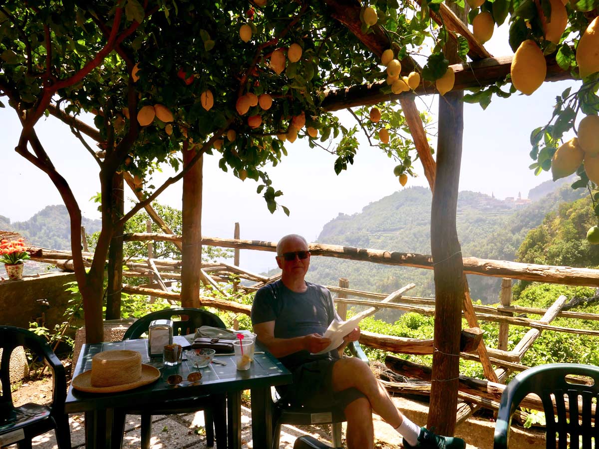 Reading under lemon trees hiking the amalfi coast in Italy