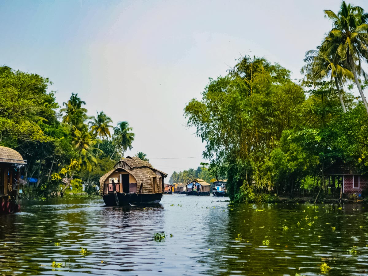 Riverside homes and houseboats in chanels of Kerala India