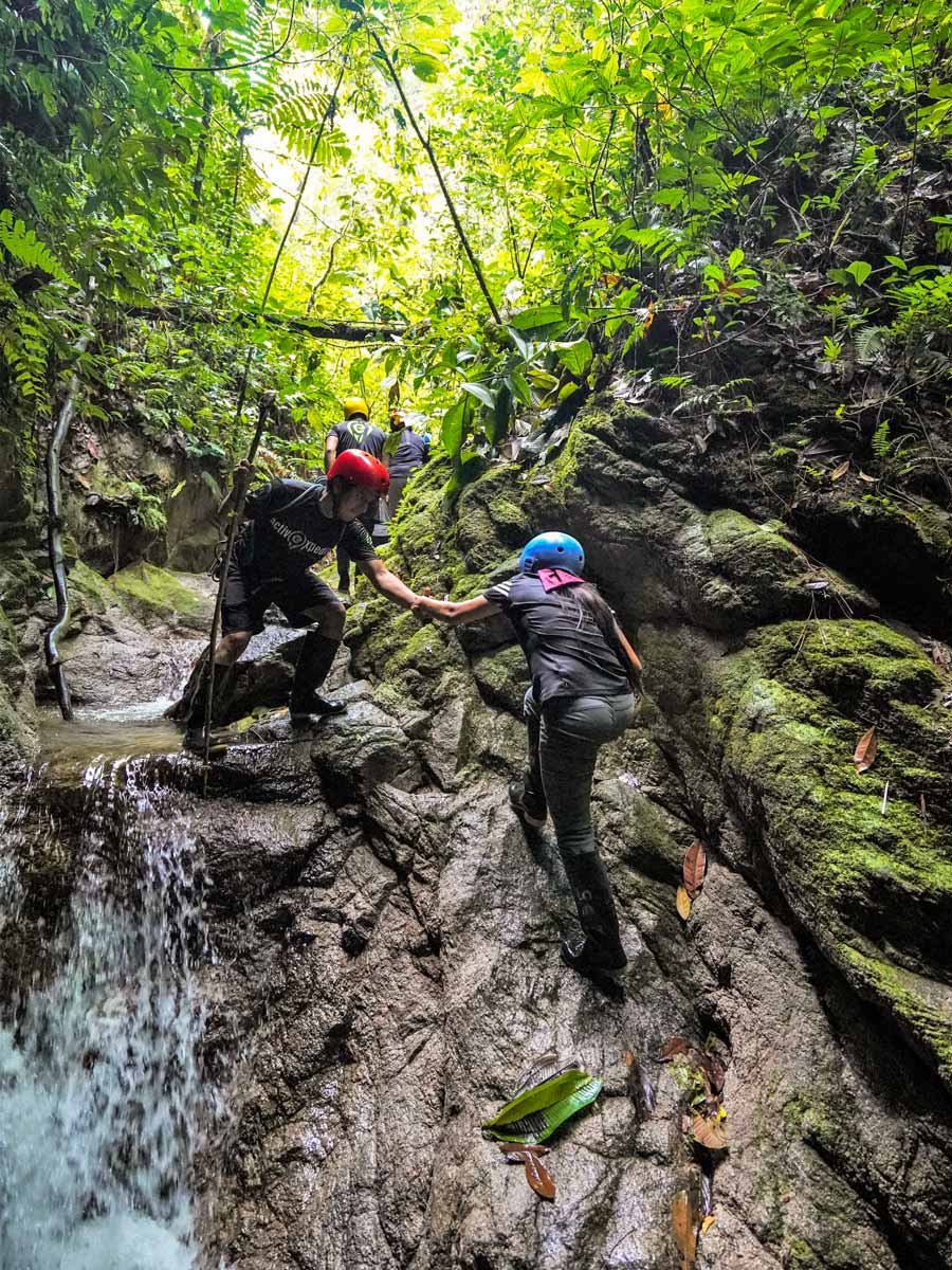 Climbing natural waterfalls along adventure tour photo Peru Ecuador