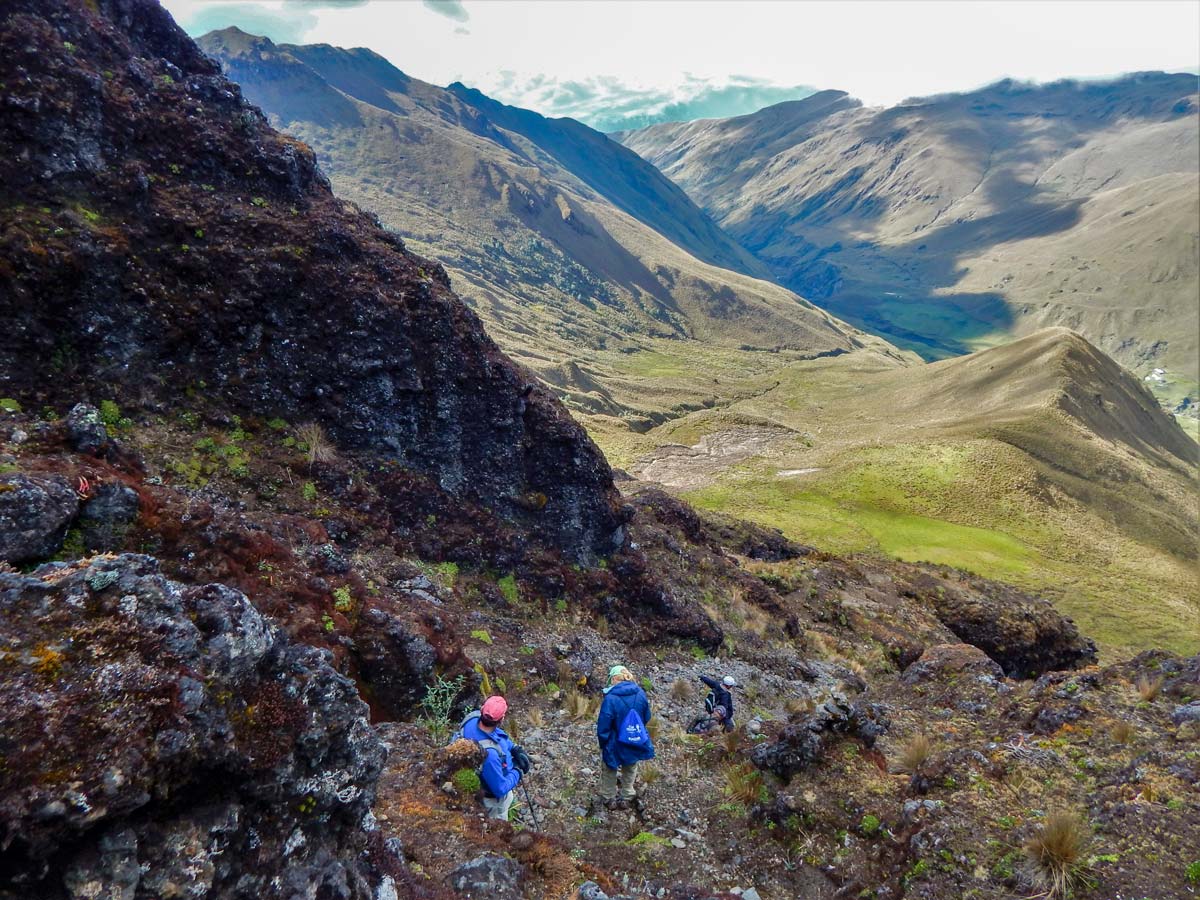 Hikers descending rock hiking trekking altar volcano Peru