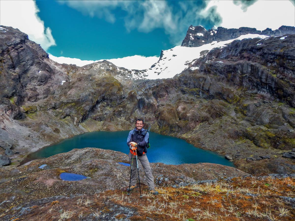 Hiker above mountain lake hiking trekking altar volcano Peru