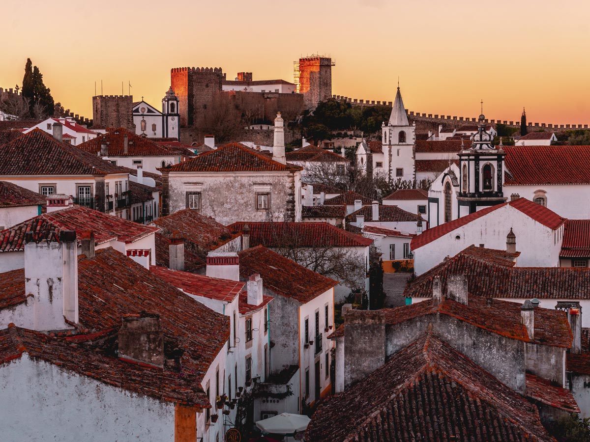 Óbidos Portugal red tile roofs city cycling tour