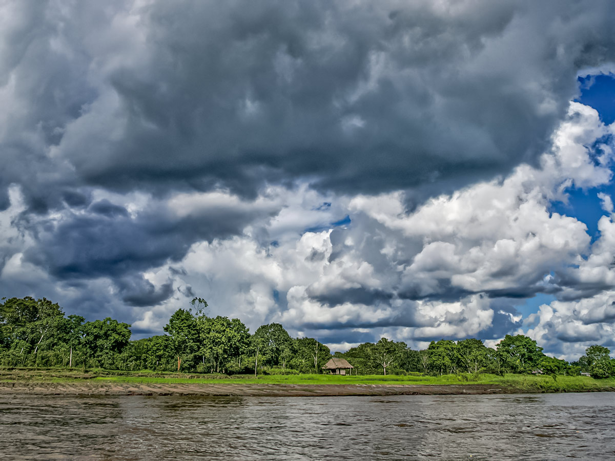 Storm clouds over river bank Peruvian Amazonia survival training expedition