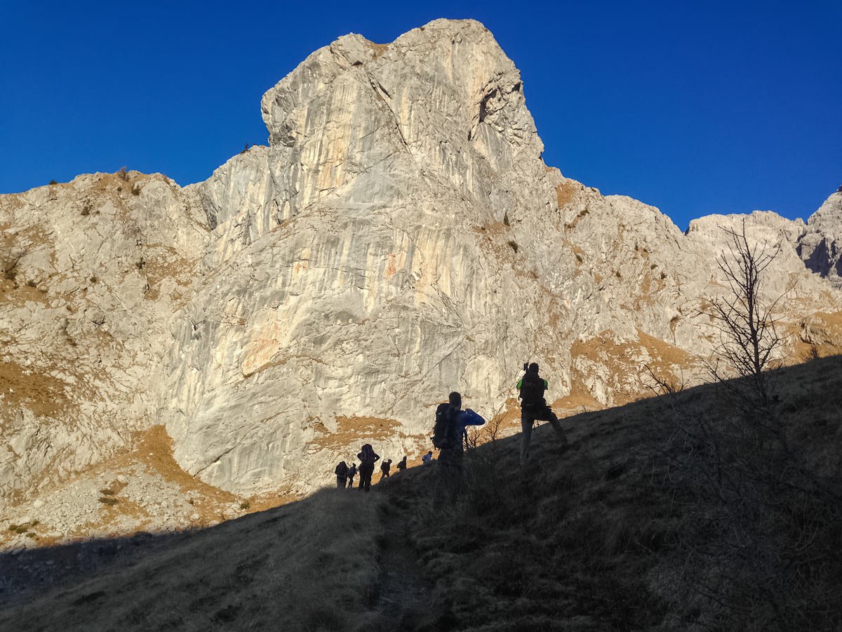 Hikers take photos of peaks hiking in the friulian dolomites Italy