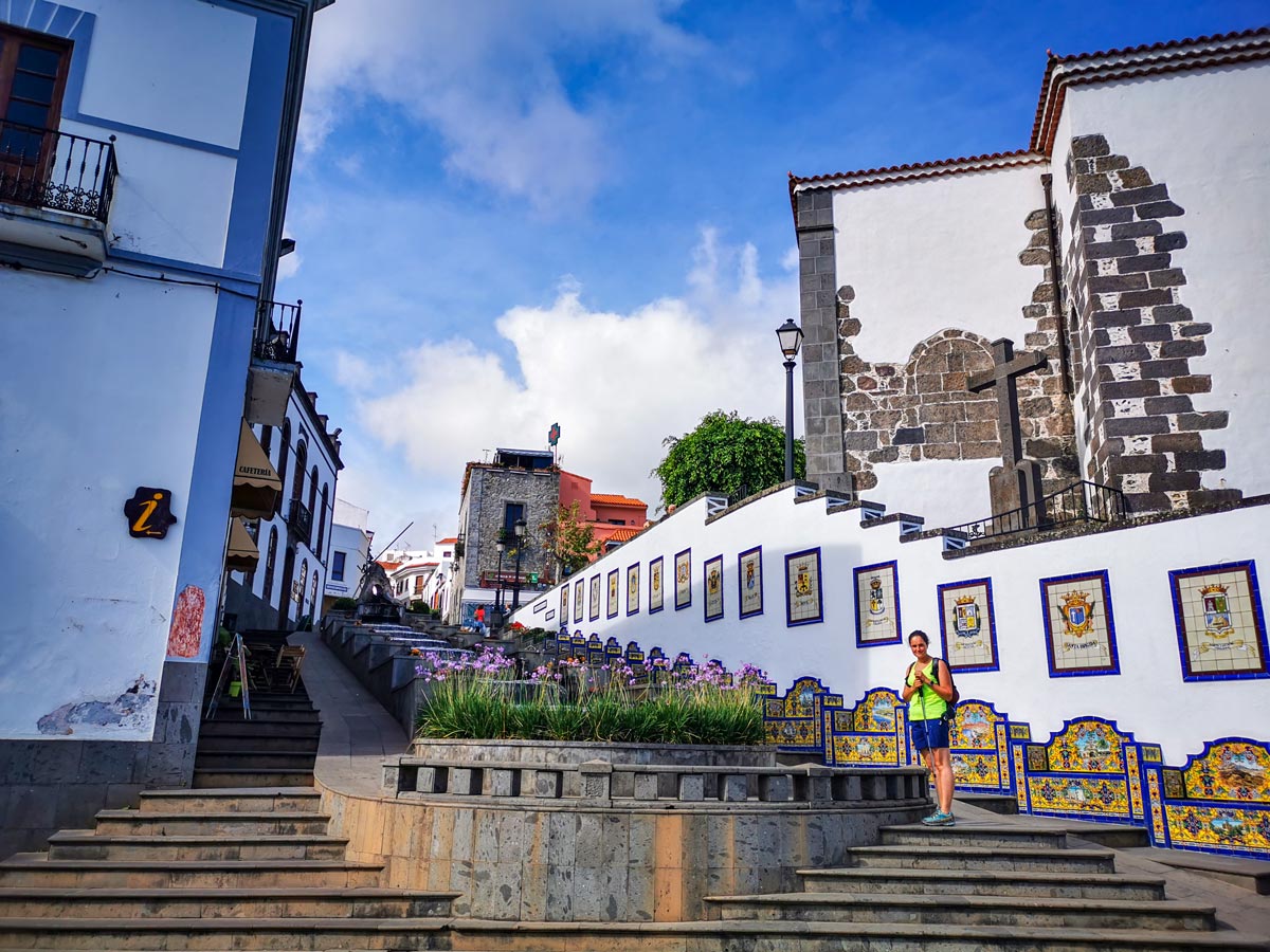 Firgas hiker on city steps tile mosaic hiking tour Spain