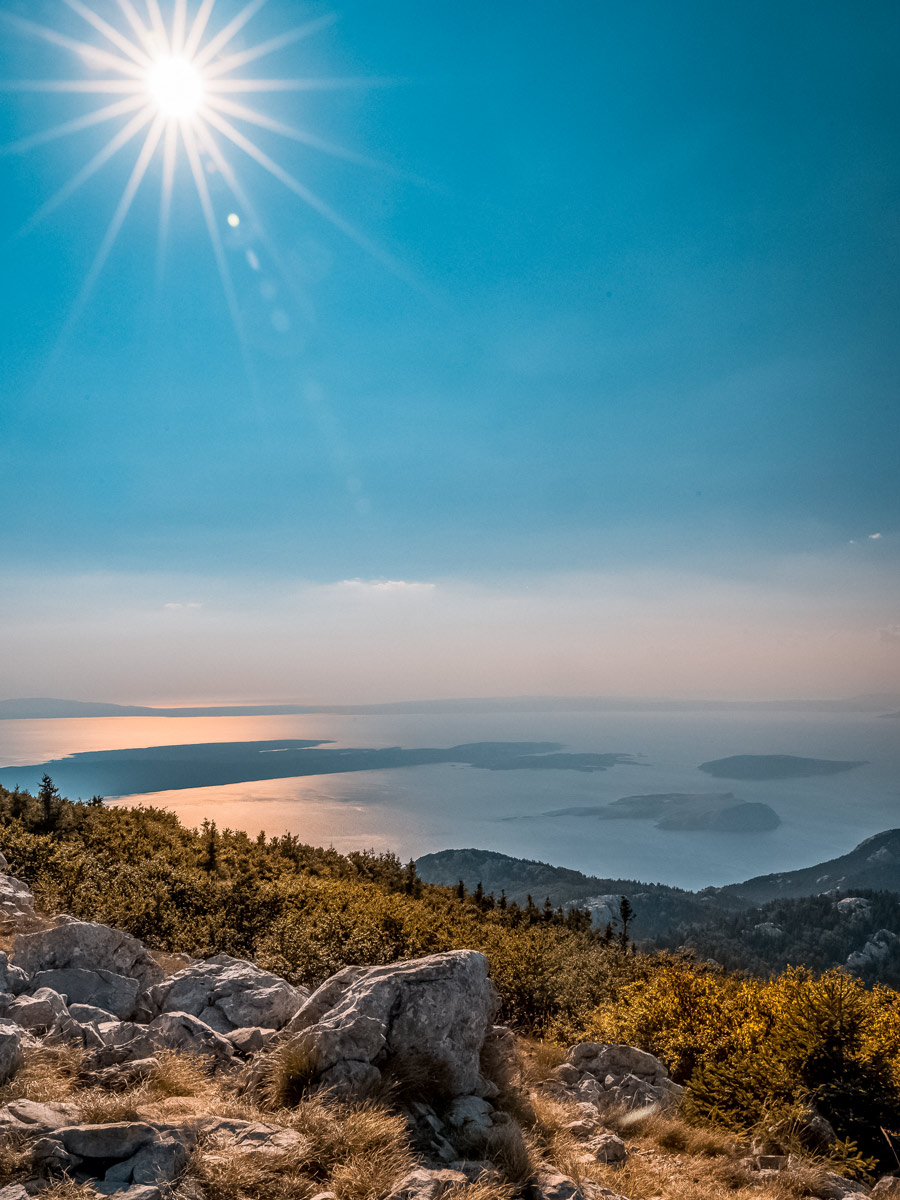 Beautiful hazy ocean view sunrays hiking walking adventure tour in Croatia