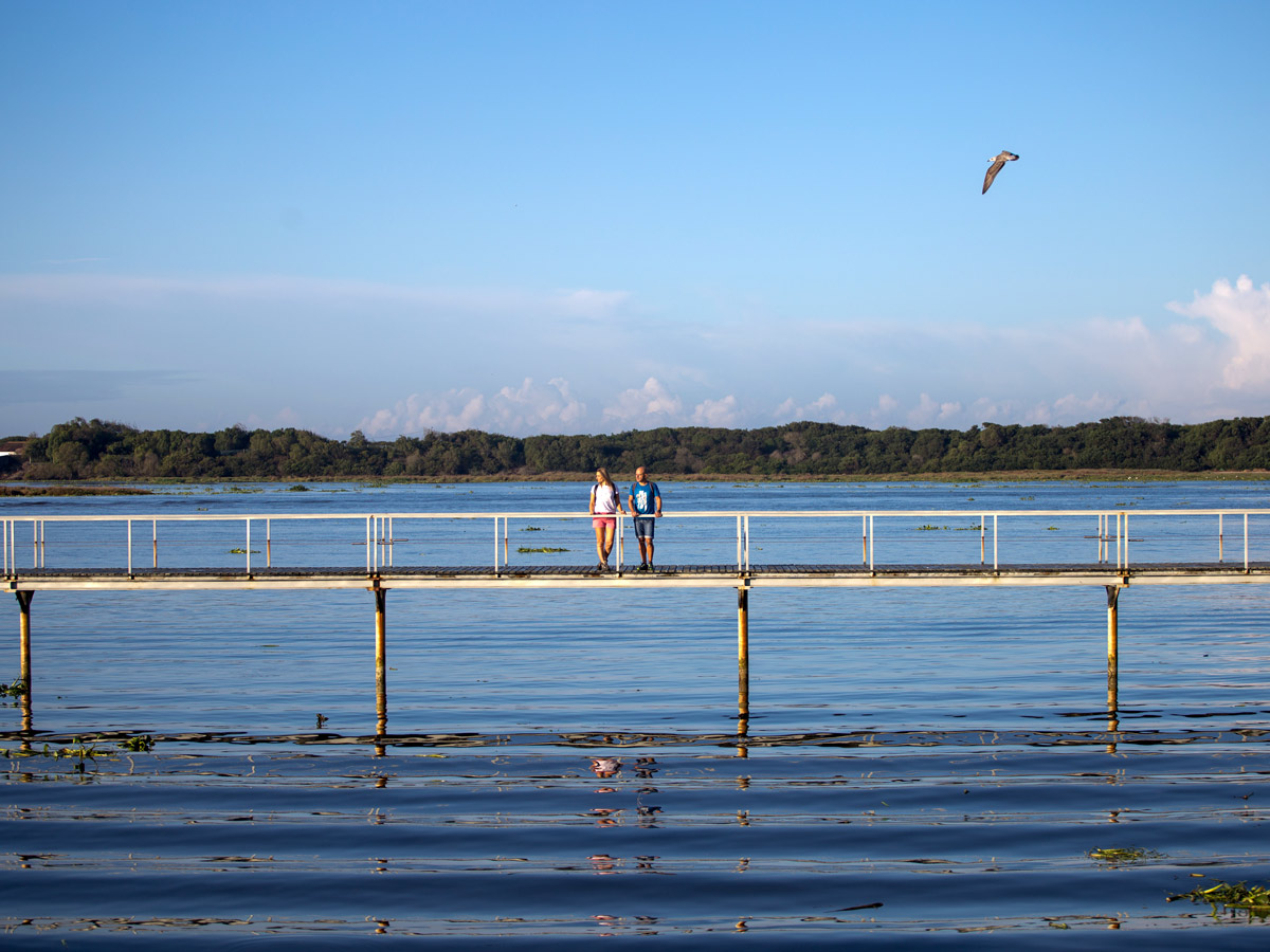 Couple on the pier walking path over the water adventure tour Portugal Atlantic coast