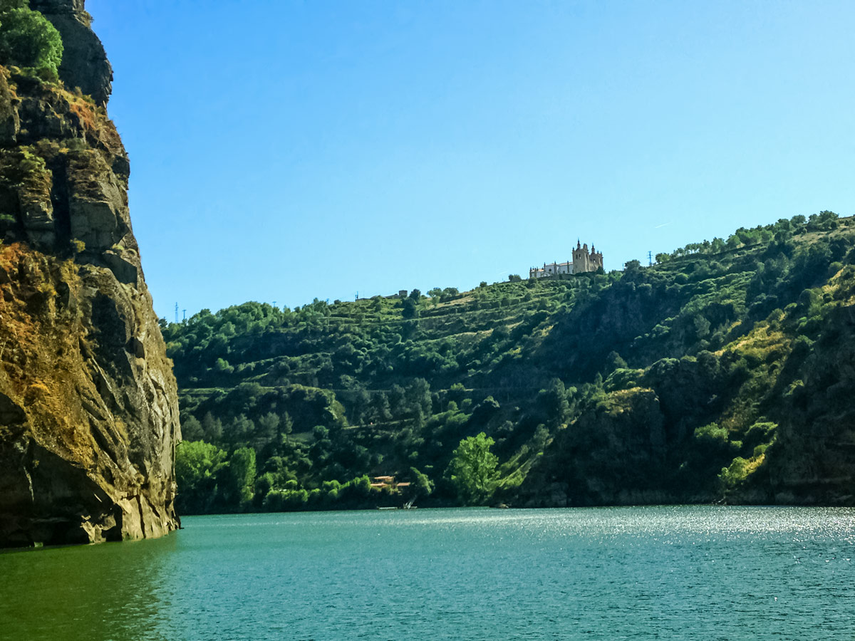 Castle high on the mountain above river ocean