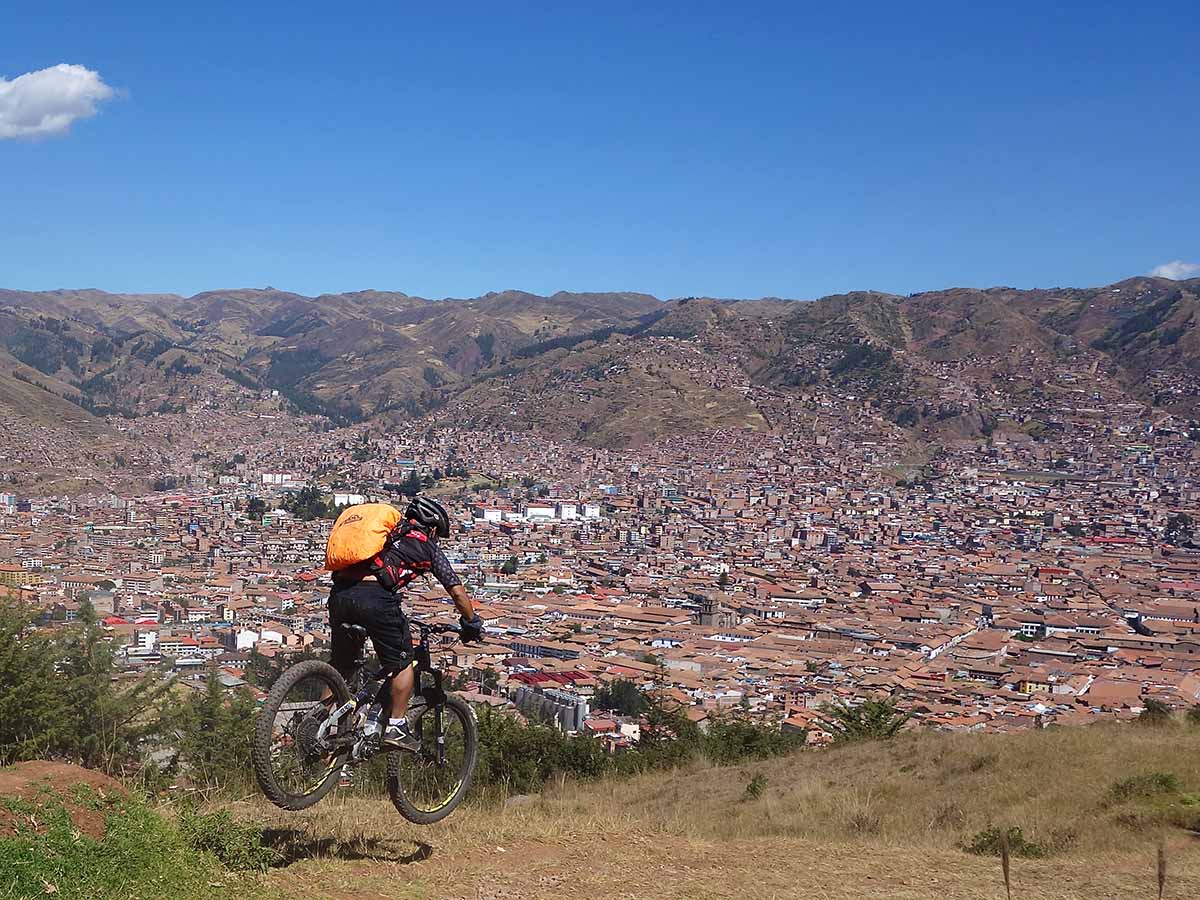 Mountain biking in Peru with a Cusco in background