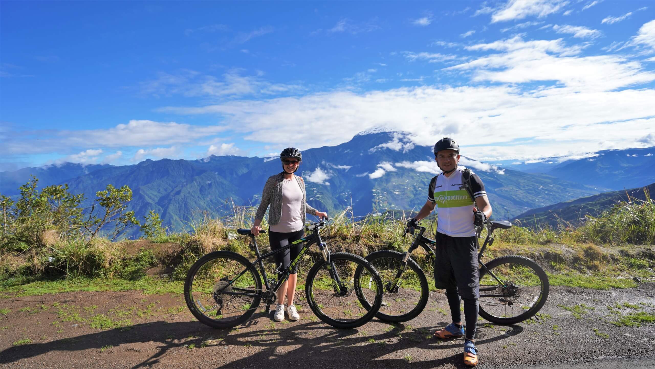 Cyclists posing in front of the mountain view (Ecuador rainforest biking tour)