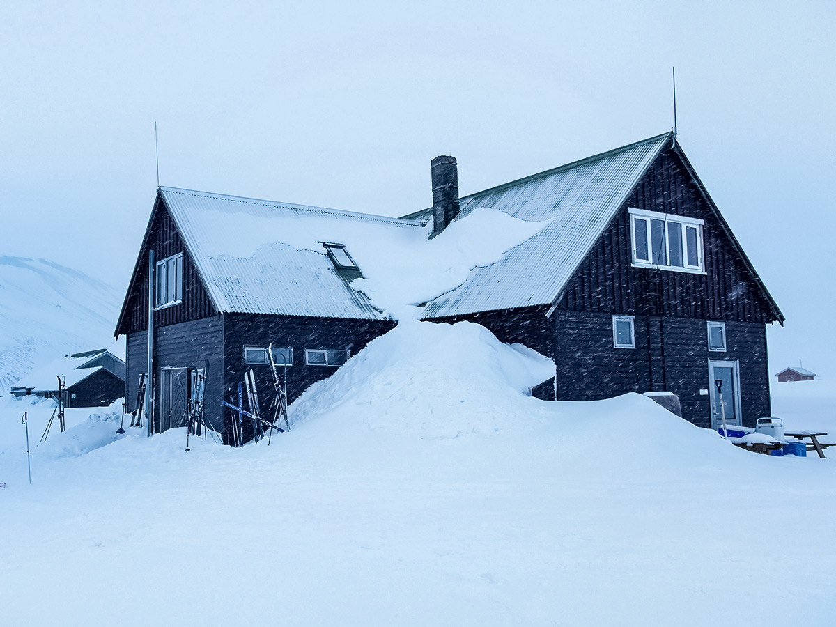Cabin hut burried in snow Landmannalaugar cross country nordic ski adventure trek