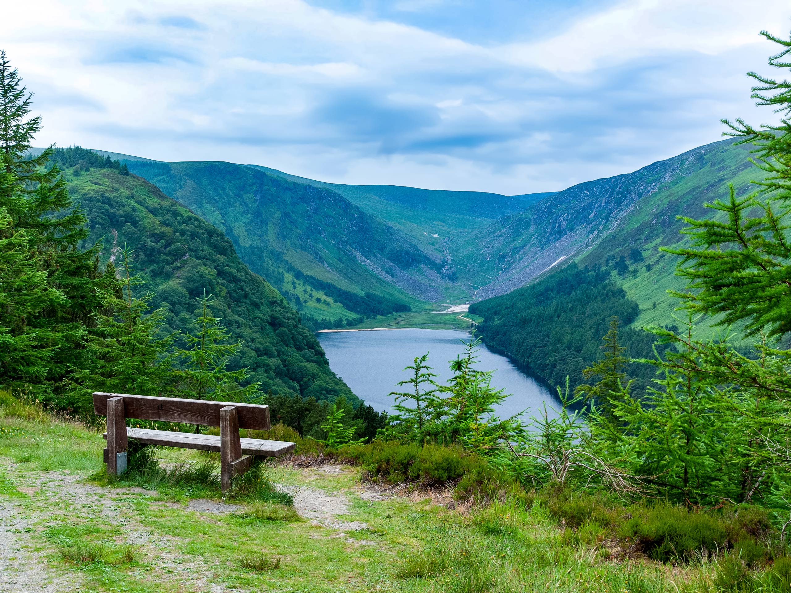 Bench overloocking small lake Loch pond hiking in Glendalough, County Wicklow, Ireland