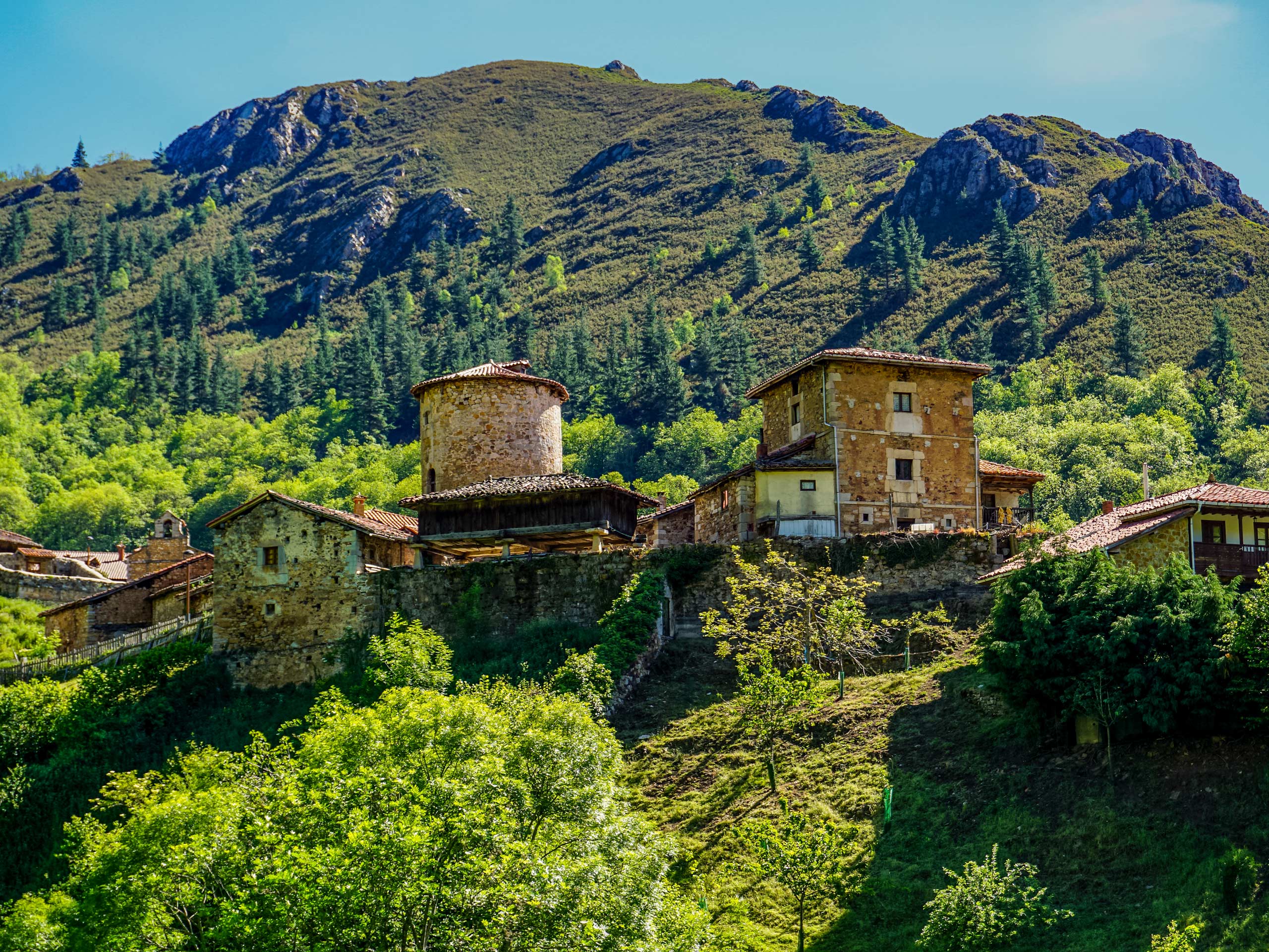 Stone brick homes on the hillside of bandujo sts ana hiking in Spain Asturias walking circular lagos