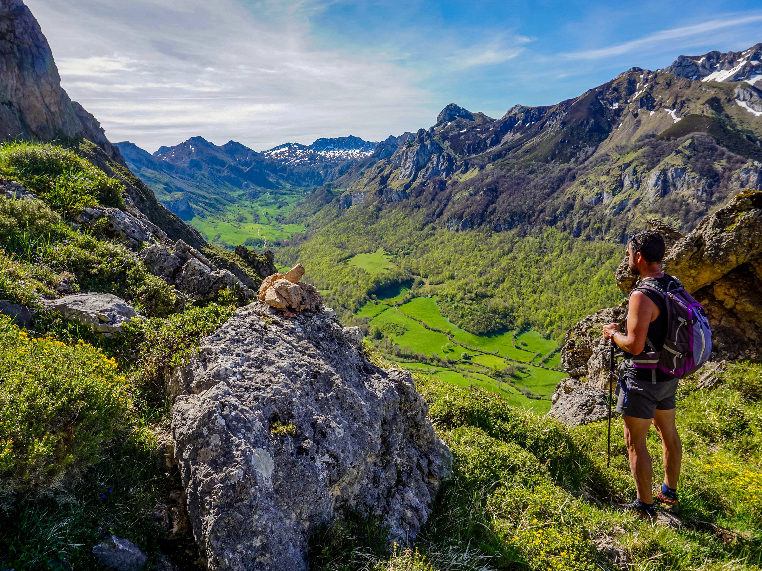 Hikers admiring view of green valley hiking in Spain Asturias walking circular lagos