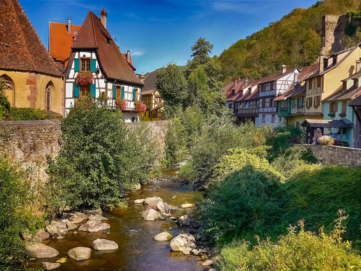 Kayserberg village on the river exploring wine route Alsace France