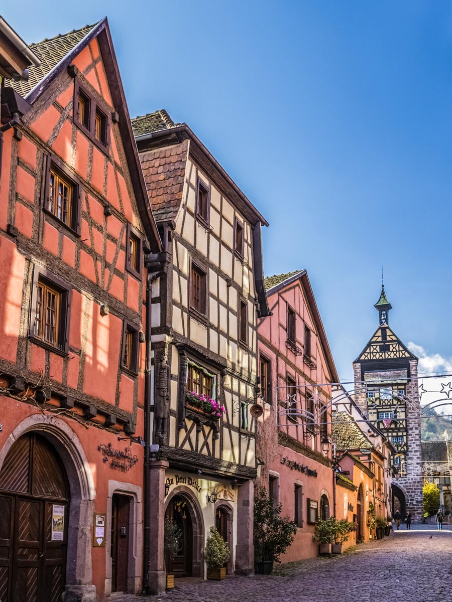 Riquewihr village town houses on cobblestone street exploring wine route Alsace France