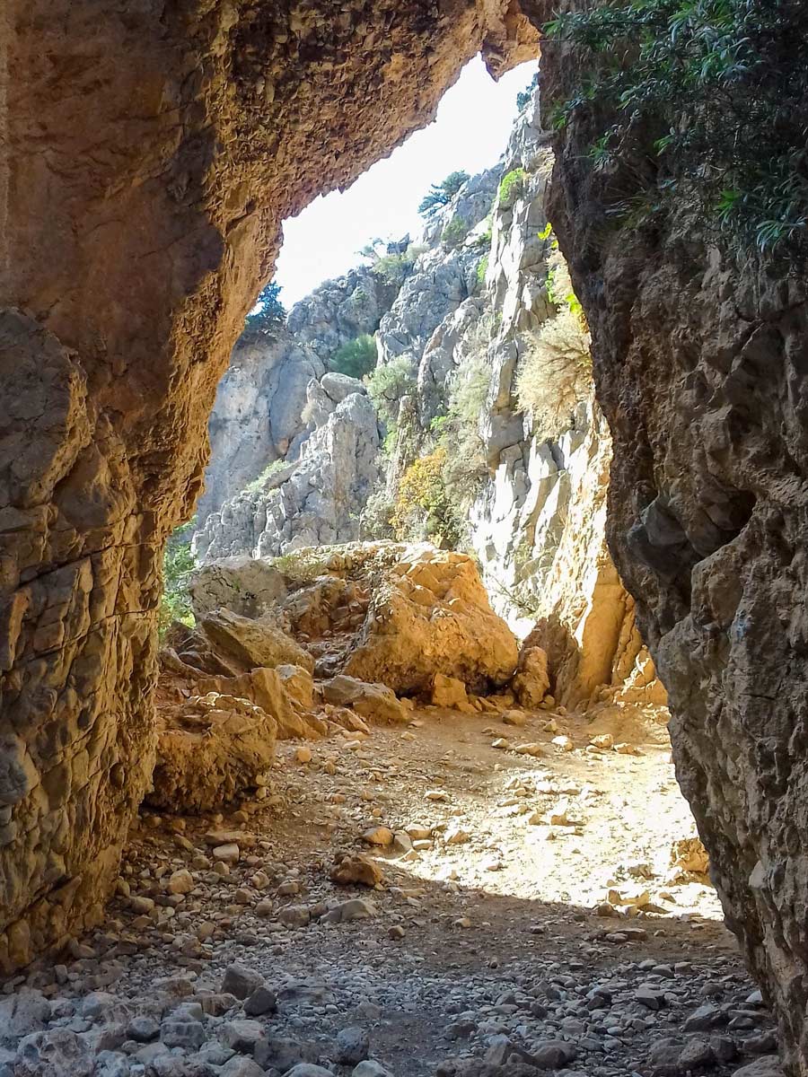 Stone arch cave exploring Crete Greece coastline adventure tour