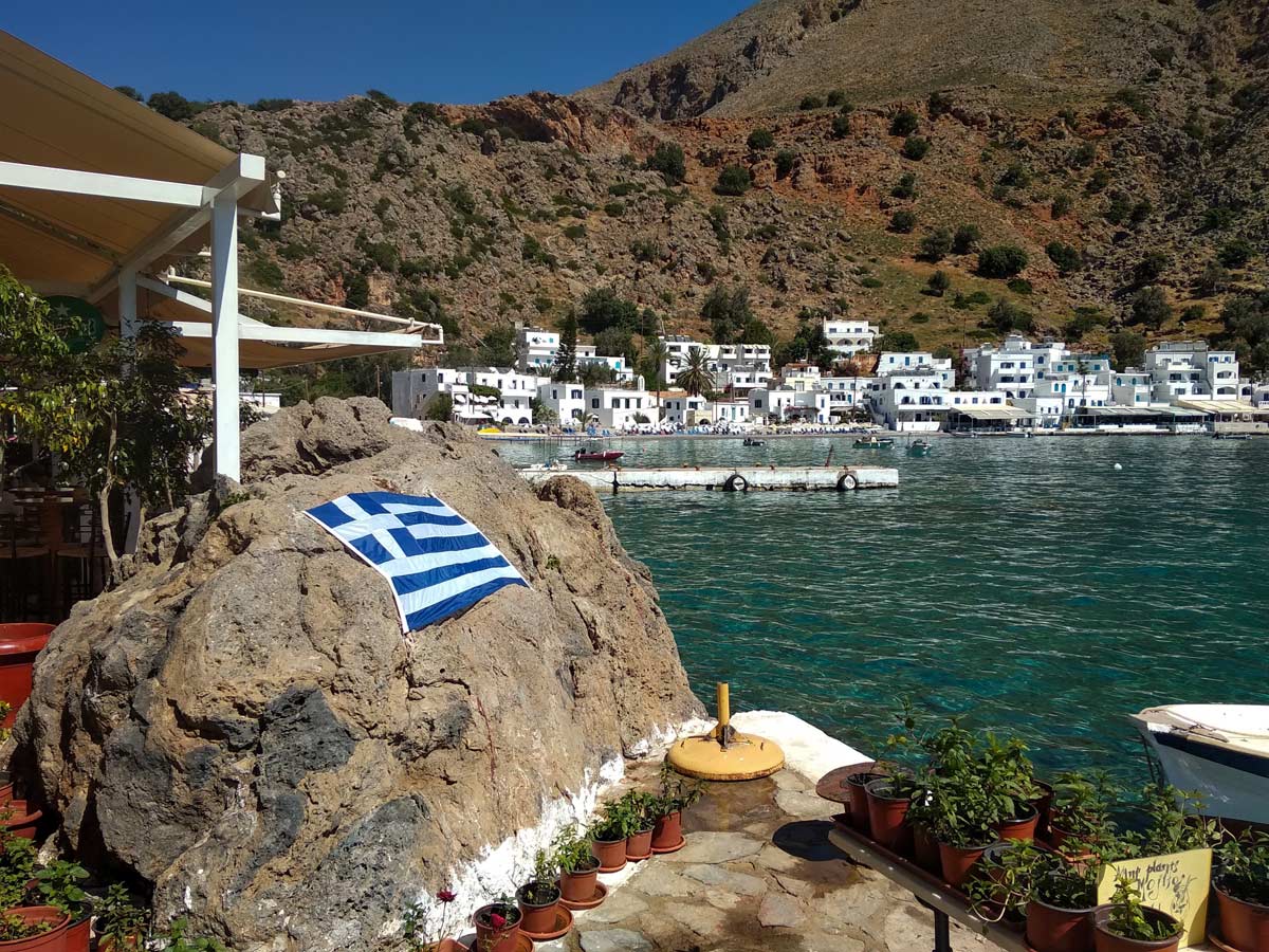 Greek flag cove harbour walking Crete Greece west adventure walking tour