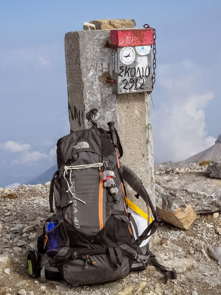 Backpack summit marker Litochoro Olympus hike exploring Greece