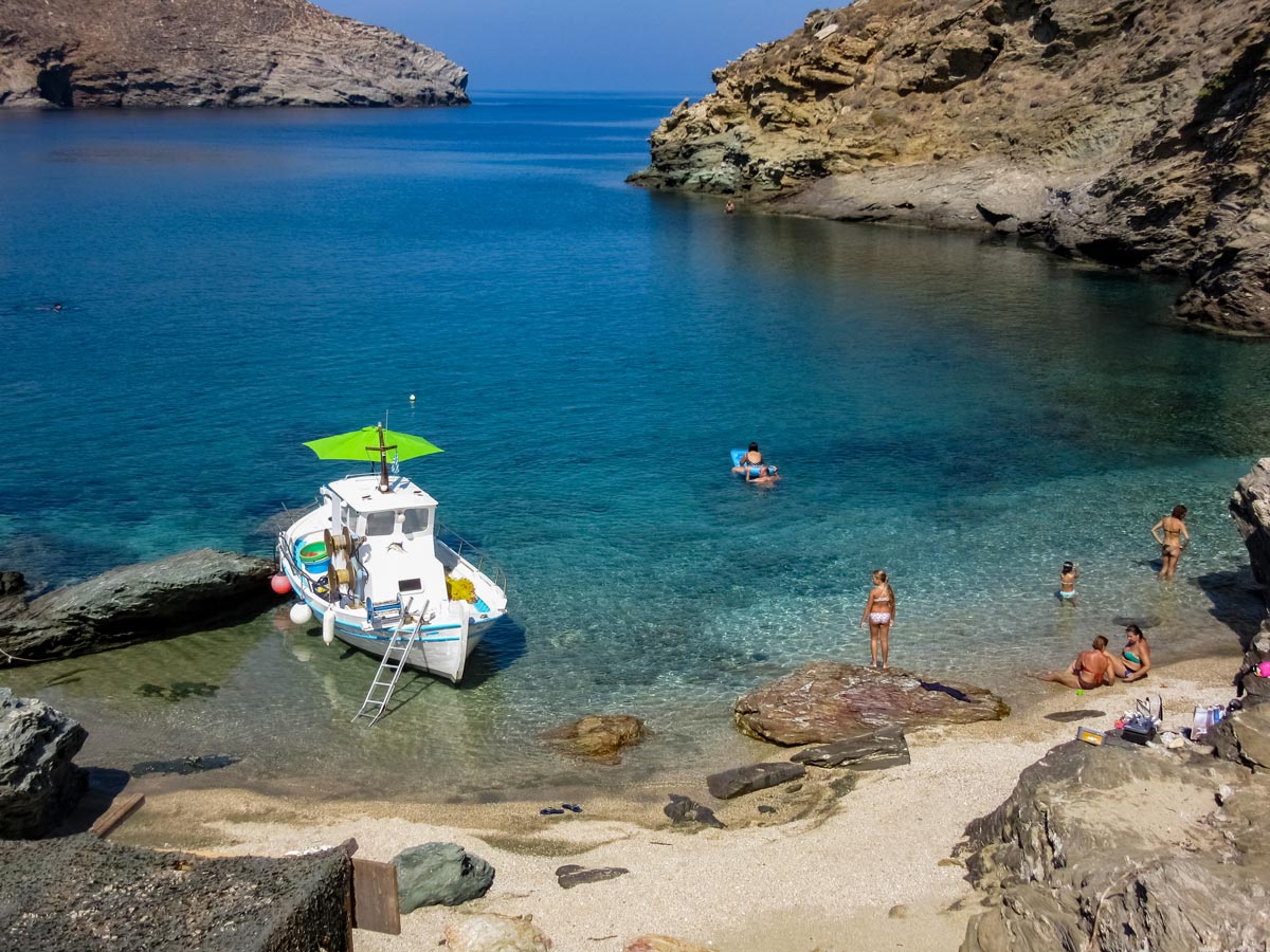Achla Bay with Boat exploring Tinos Greece
