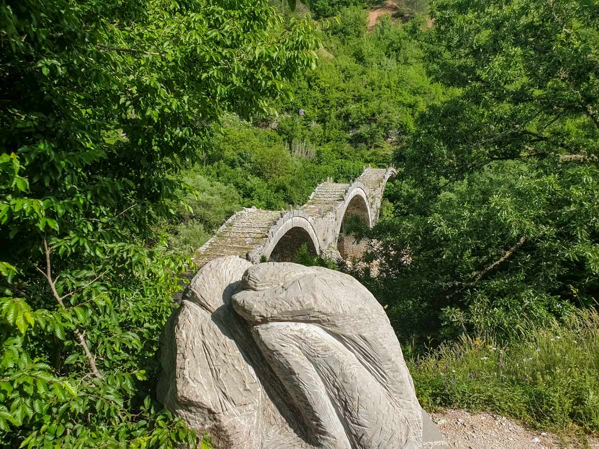 Kipi bridge with carved statue hiking Zagori Vikos Gorge Greece