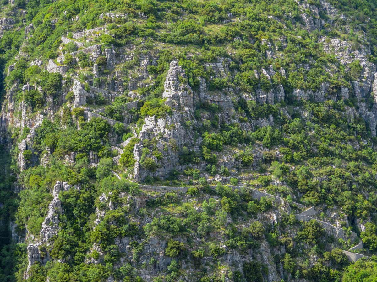Vradheto steps carved into mountainside Vikos Gorge hiking tour Greece