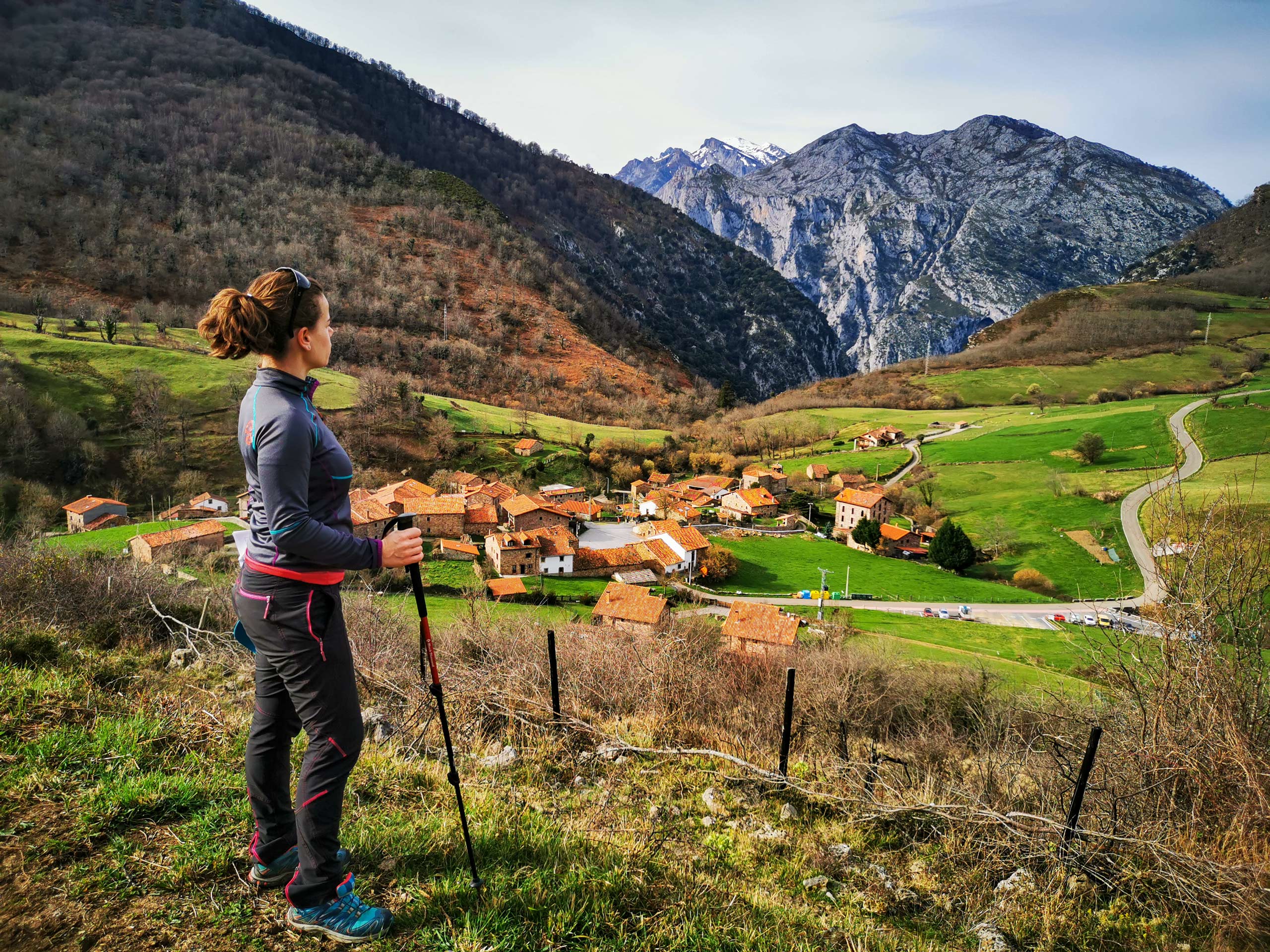 Camino Lebaniego hiker admiring the view over valley village Spain